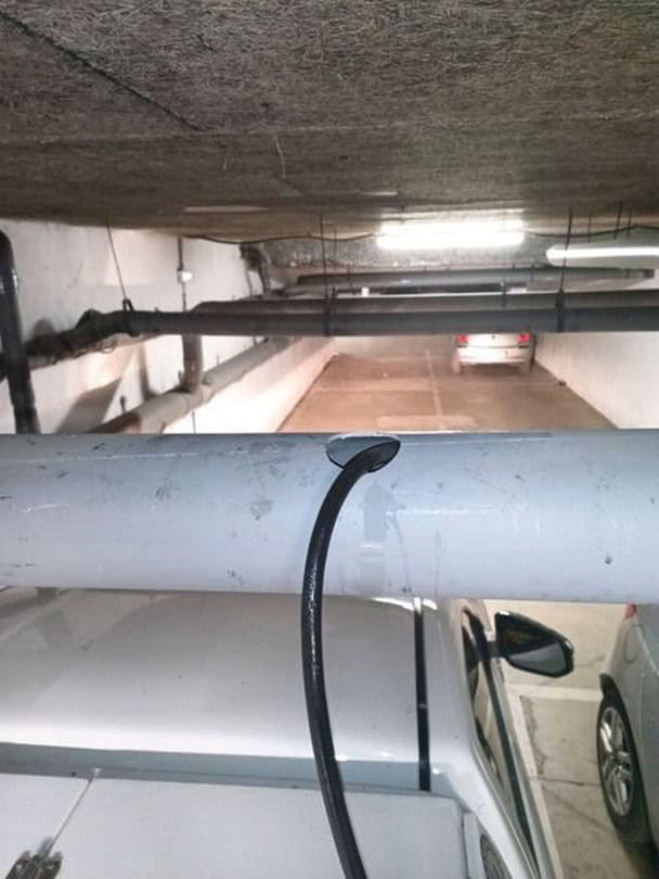 Passage caméra dans une canalisation en PVC dans un parking d'immeuble